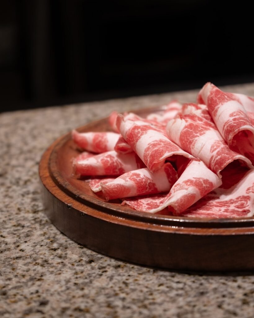 a plate of raw meat on a counter